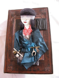 'Justice' Paper Doll on Book Cover. Silk, organza, thread, NZ wool, stamping, embossing, charms, air clay.